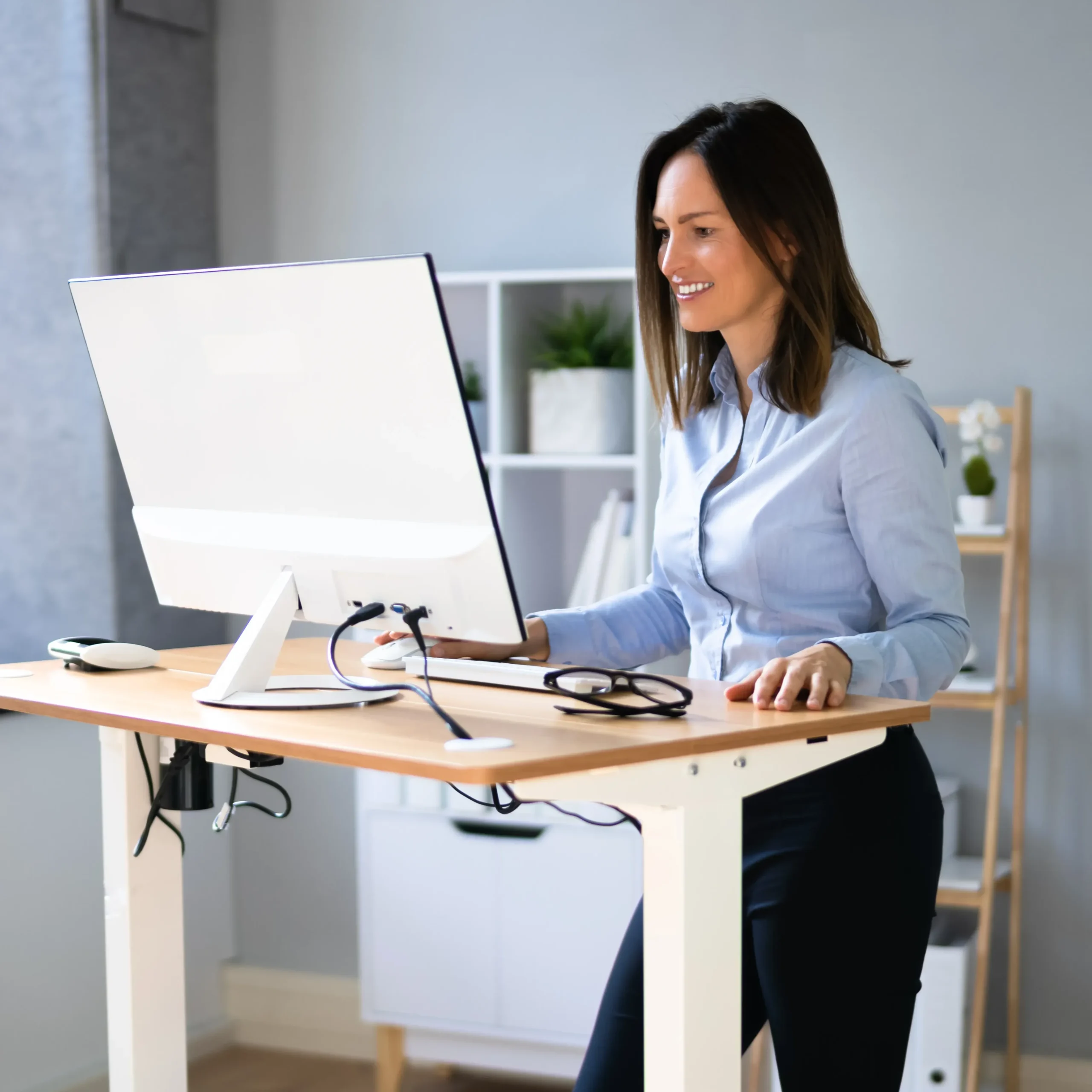 Woman standing at desk with good posture