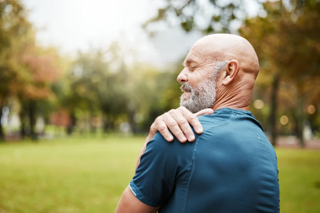 Man holding his shoulder showing signs of pain